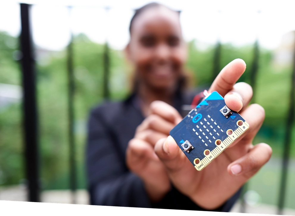 a pupil holding a micro:bit 168 up close to the viewer